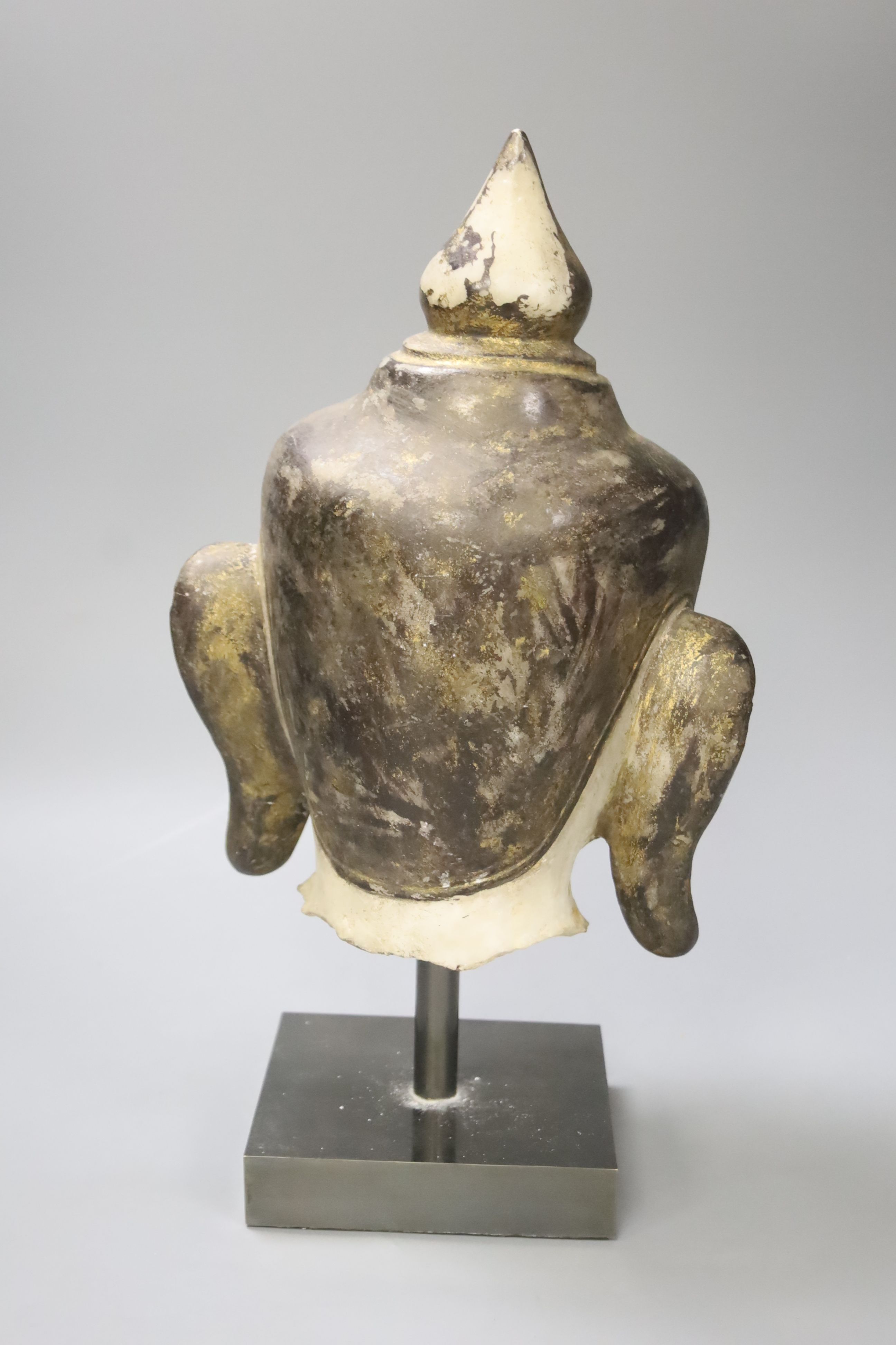 An 18th century Burmese white marble Shan-Style Buddha’s head, on stand, bought in 1995 in Burma or Myanmar, height 36cm